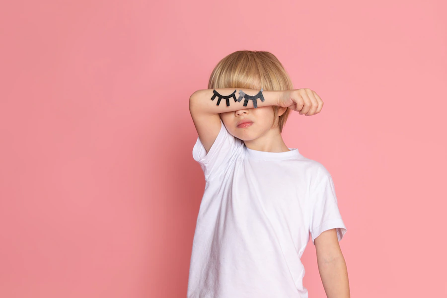 front-view-kid-white-t-shirt-with-hands-closed-eyes-pink-desk_179666-1126.jpg